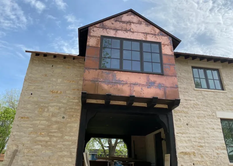Copper metal panel facade on a stone building for Skylight Installation in Orcutt